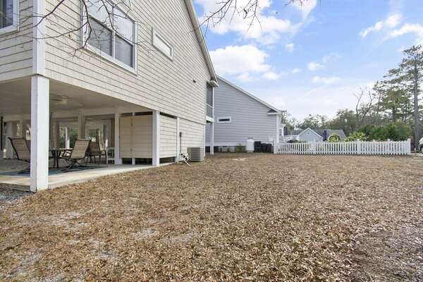 Spacious backyard at Old Ferry Coastal Retreat with covered outdoor seating area and plenty of open space for activities