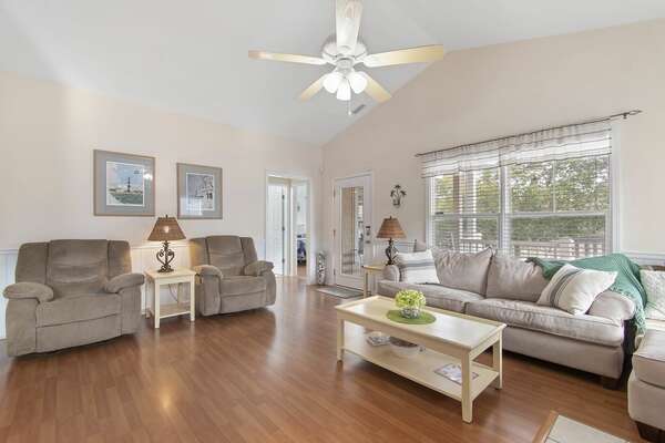 Cozy living space with recliners, plush couch, and natural light at Old Ferry vacation rental
