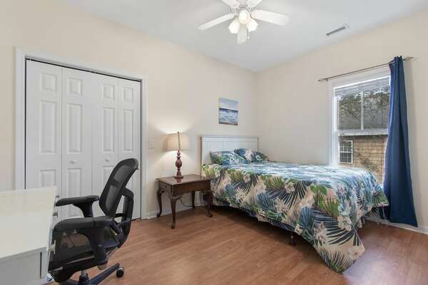 Guest room with bed, desk, and office chair at Old Ferry Coastal Retreat
