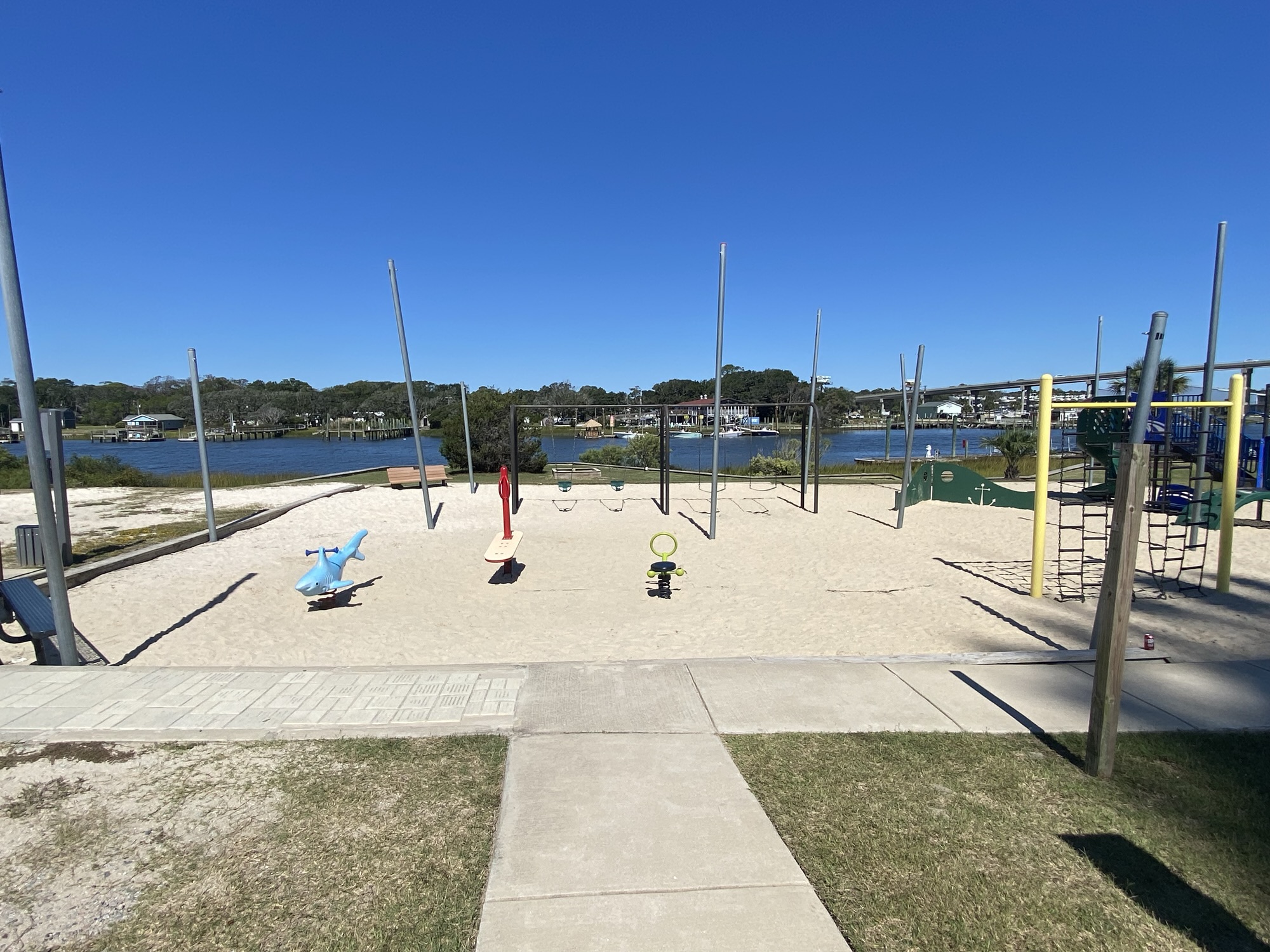Playground with swings and water views at Holden Beach park