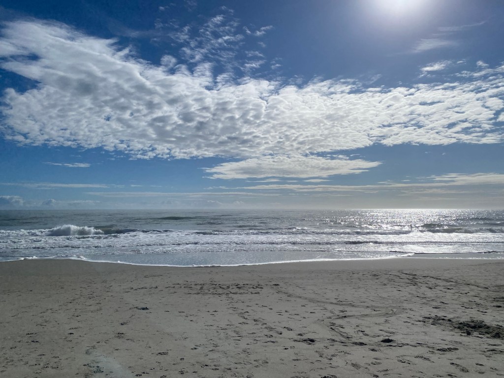 Sunlight reflecting off the ocean waves at Holden Beach, NC with a peaceful sandy shoreline