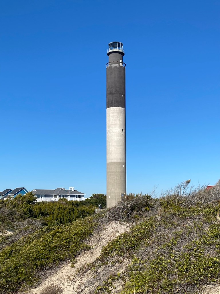 Vertical view of Oak Island Lighthouse against a clear sky