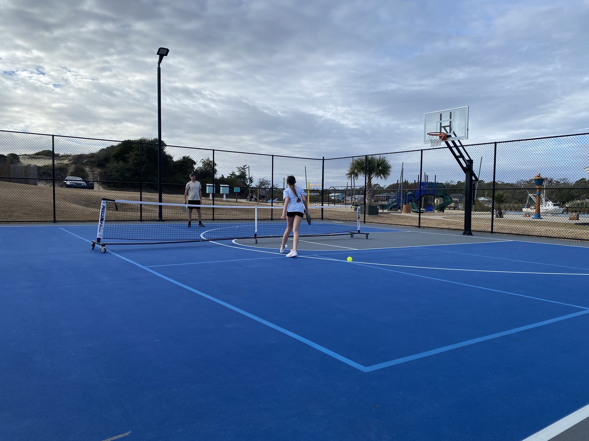 Couple playing pickleball at the Holden Beach courts