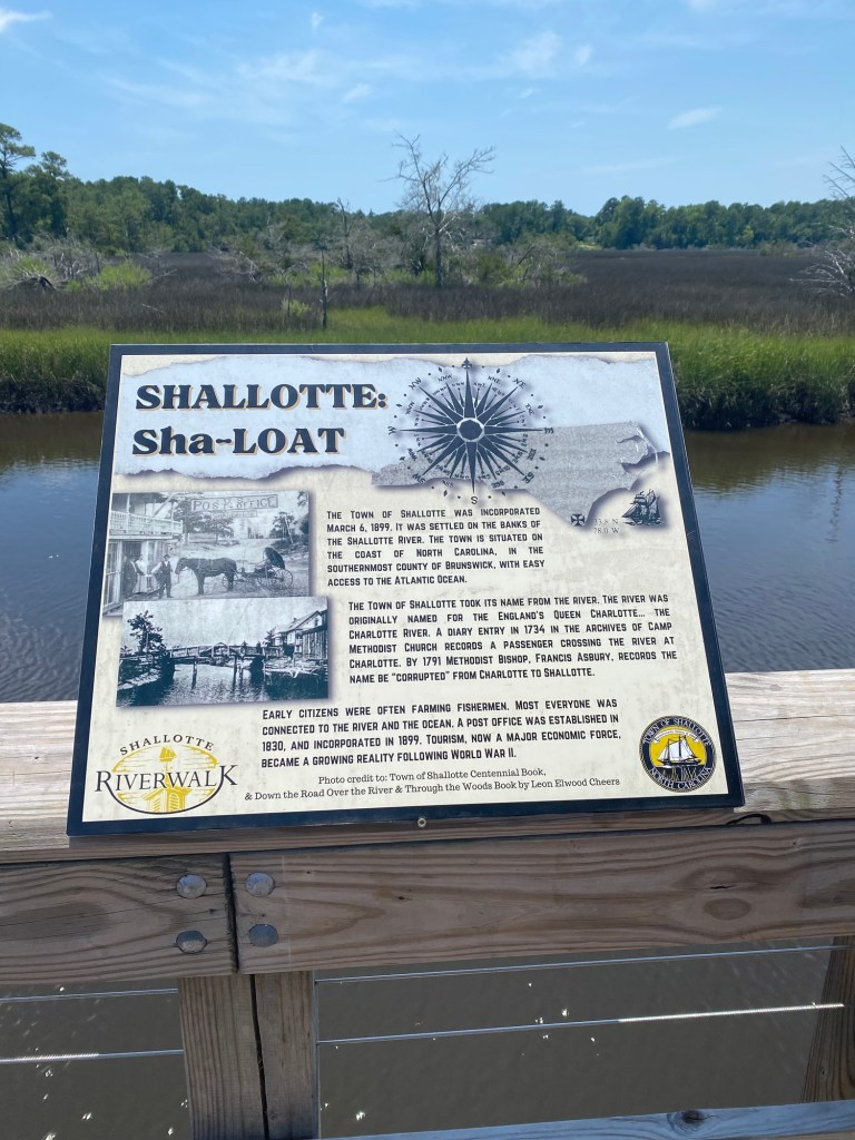 Historical marker at Shallotte Riverwalk with marsh in background